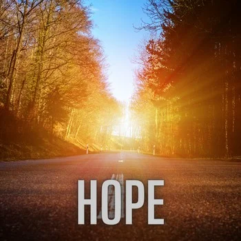 sun shining through an avenue of trees and the word hope