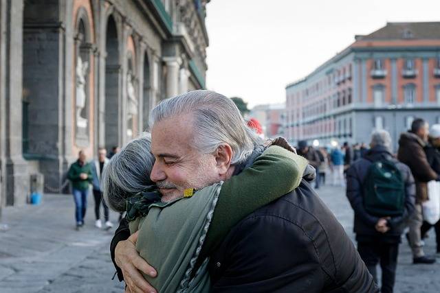 man and woman embracing in city street